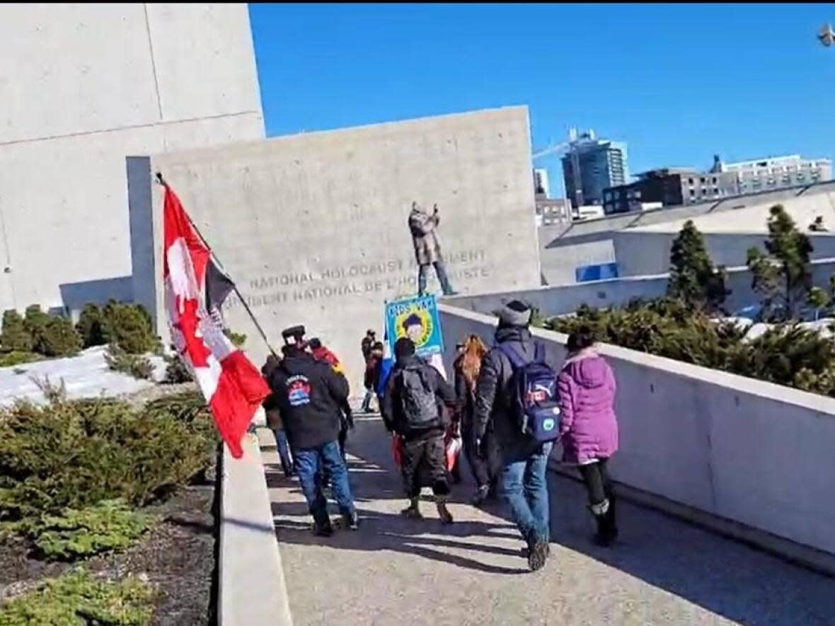 People make their way into the National Holocaust Monument in Ottawa on April 2, 2023. The Friends of Simon Wiesenthal Center is condemning the gathering, saying that people there compared COVID-19 vaccination restrictions to the horrors of the Holocaust. (Friends of Simon Wiesenthal Center - image credit)