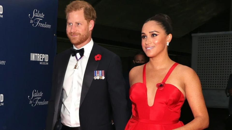 Prince Harry and Meghan Markle in black tie on a red carpet