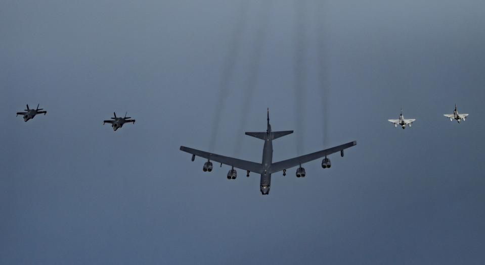 In this Tuesday, May 21, 2019 photo, Qatari Air Force Mirage 2000s, right, a U.S. B-52H Stratofortress, center, and U.S. F-35A Lightning IIs fly in formation over Southwest Asia in an undisclosed location. (Senior Airman Keifer Bowes/U.S. Air Force via AP)