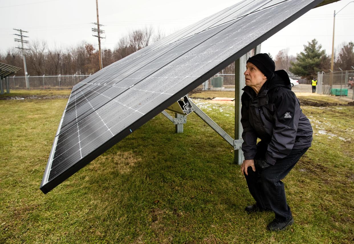 Bob Ducker, a Sierra Club supporter, inspects the electrical components under the solar panels of the city's newly completed solar farm before its official unveiling Thursday, Dec. 13, 2018. [Ted Schurter/The State Journal-Register]