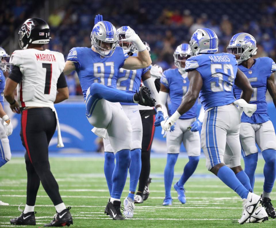 Lions defensive end Aidan Hutchinson (97) celebrates after tackling Falcons quarterback Marcus Mariota (1)  during the first half of a preseason game Aug. 12, 2022 at Ford Field.