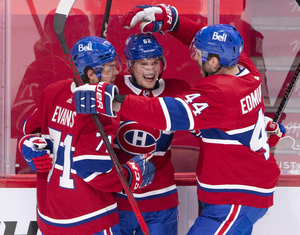 Montreal Canadiens' Artturi Lehkonen (62) celebrates with teammates Jake Evans (71) and Joel Edmundson (44) after scoring the tying goal during the third period of an NHL hockey game against the Edmonton Oilers, in Montreal, Monday, May 10, 2021. (Ryan Remiorz/The Canadian Press via AP)