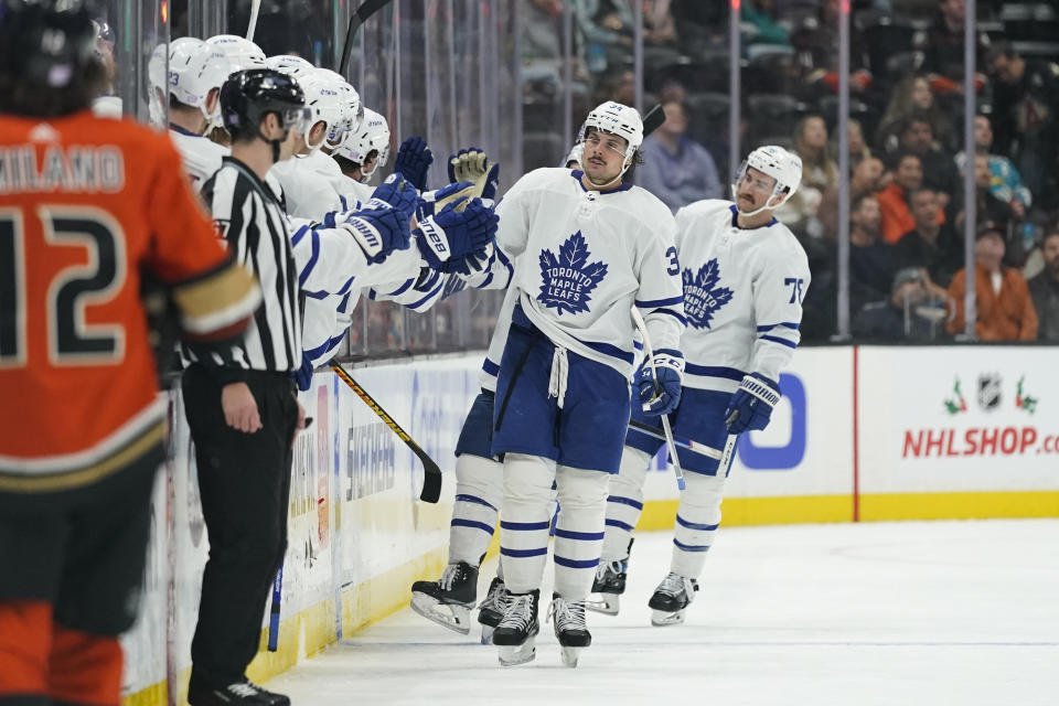 Toronto Maple Leafs' Auston Matthews, center, celebrates his goal with teammates during the second period of an NHL hockey game against the Anaheim Ducks Sunday, Nov. 28, 2021, in Anaheim, Calif. (AP Photo/Jae C. Hong)