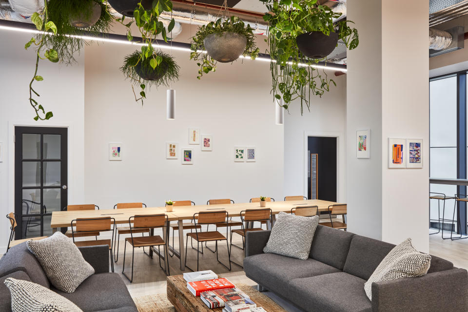 The Collective Canary Wharf's co-working lounge is featured in this photo.