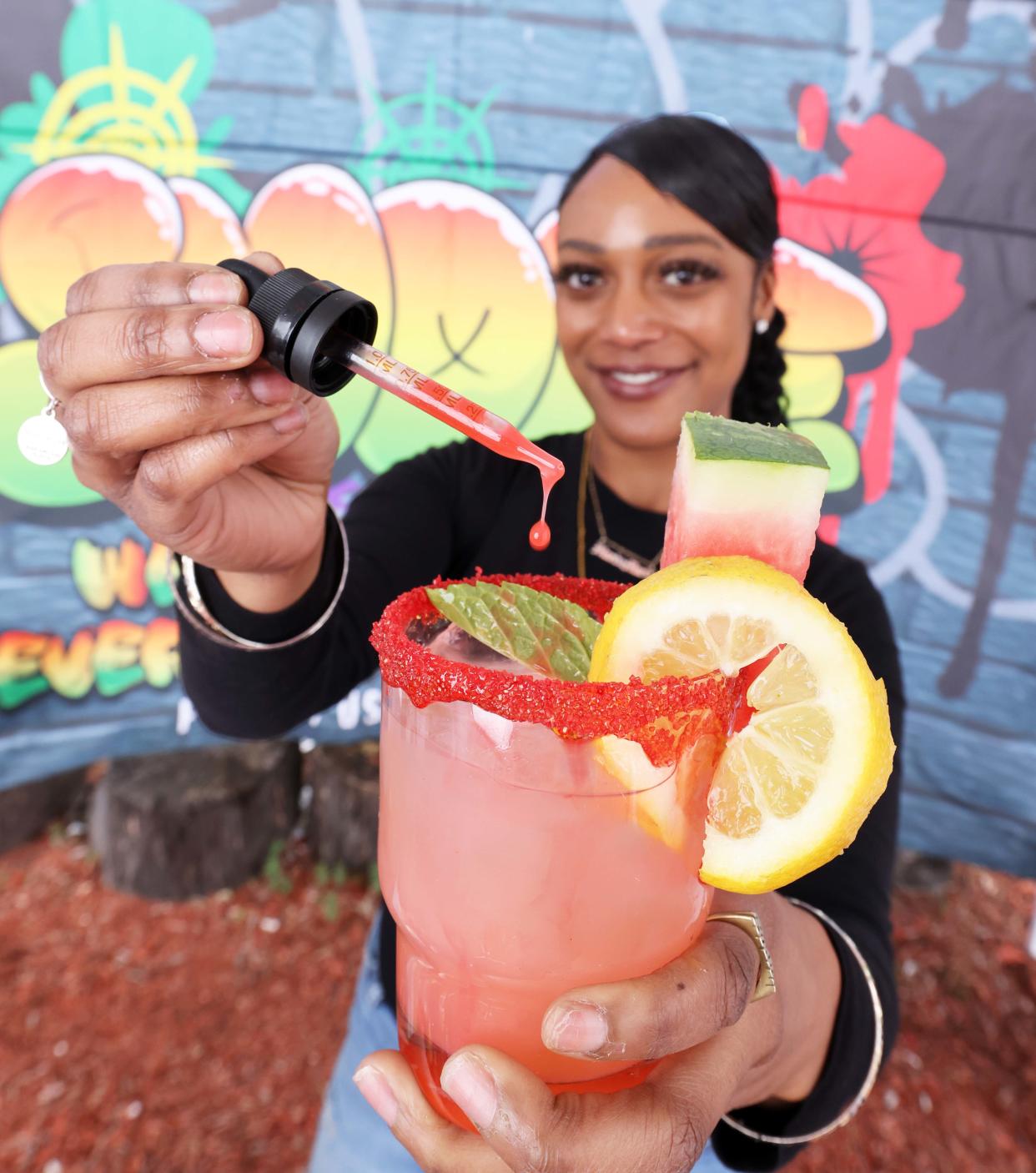 Amanda Barros outside Legal Greens with a cannabis-infused drink in Brockton on Wednesday, April 17, 2024.