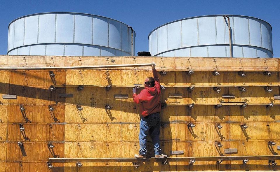 Bryan De Lurgio removes concrete forms April 13, 2005, for a retaining wall in a water tank replacement project. The Morro Bay structures were damaged in the San Simeon Earthquake.