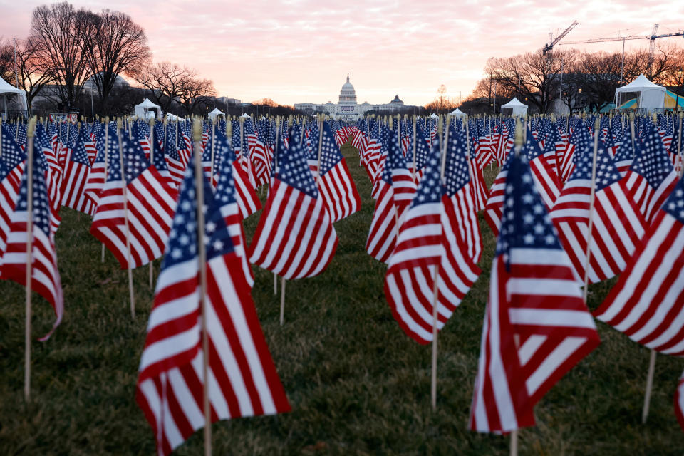 Thousands of U.S. flags are seen at the National Mall as part of a memorial paying tribute to people across the country who have died from the coronavirus, near the U.S. Capitol ahead of President-elect Joe Biden's inauguration, in Washington, on January 18, 2021. / Credit: Carlos Barria / Reuters