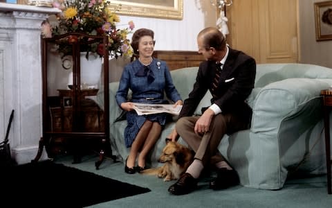 Queen Elizabeth II and the Duke of Edinburgh during their traditional summer break at Balmoral Castle. The royal couple are seen with 'Tinker', a cross between a corgi and long haired dachshund - Credit: PA