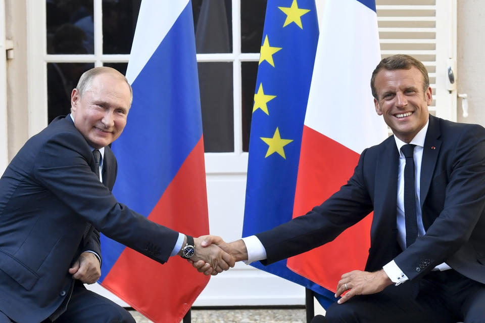 FILE - In this Aug. 19, 2019 file photo, French President Emmanuel Macron, right, shakes hands with Russian President Vladimir Putin after their meeting at the fort of Bregancon in Bormes-les-Mimosas, southern France. French President Emmanuel Macron hosts the G-7 summit this weekend fresh off a meeting with Russia's Vladimir Putin, hoping to maintain his image as a global mediator at a time of deep political and economic insecurity in the world and despite President Donald Trump's open disdain for multilateral talks. (Gerard Julien, Pool via AP, File)