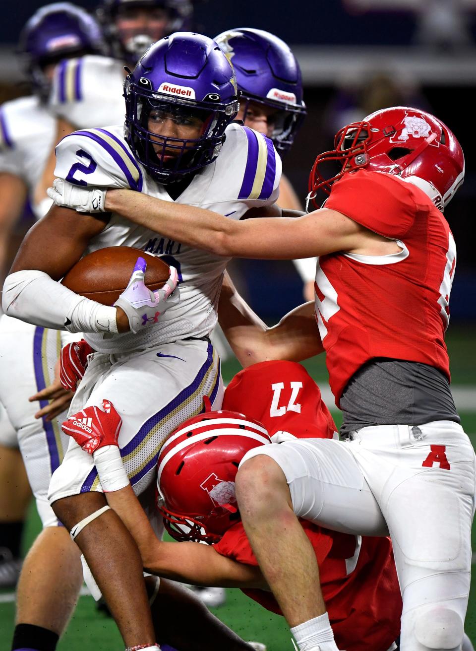 Mart running back Ja'Deriun Bell is tackled by Albany linebacker Koy Cauble and defensive back Wyatt Windham during the Class 2A Div. II state football championship Dec. 14 at AT&T Stadium in Arlington. Albany won 41-21.