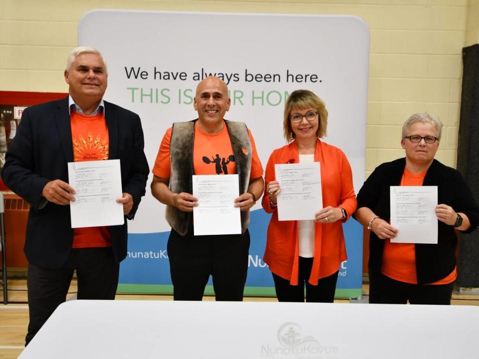 On Sept. 30, from left, Scott Reid, parliamentary secretary to the minister of education; NunatuKavut president Todd Russell; Indigenous Affairs Minister Lisa Dempster; and Christina White, the provincial English school district's assistant director of education for Labrador, signed a memorandum of understanding. (Submitted by Waylon Williams - image credit)