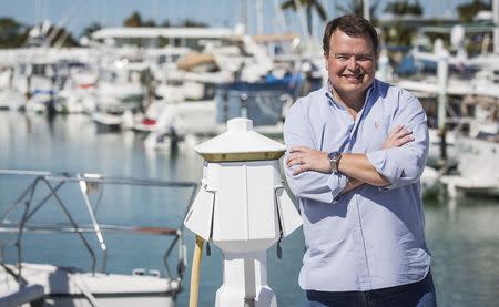 Former Air Force C-130 pilot, Brian Hall, a businessman who wants to start 4-hour round trip service between Marathon in the Florida Keys and Havana, poses for or a picture in the the Marathon Marina in Marathon, Florida February 20, 2015. REUTERS/Mark Blinch