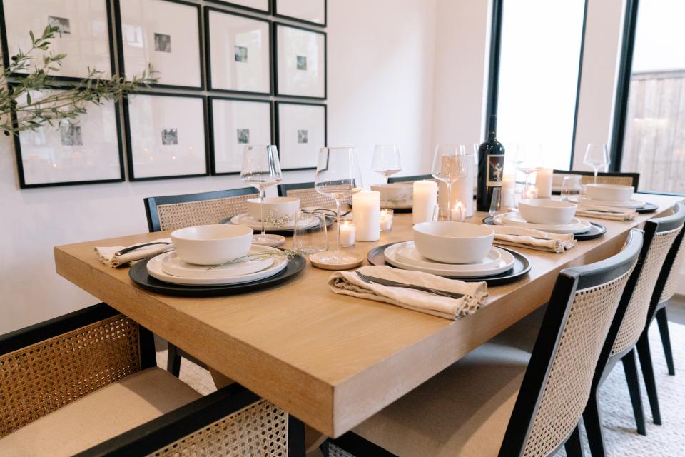 In the dining room, Pottery Barn’s Lisbon Cane dining chairs and armchairs surround the brand’s Modern Farmhouse Extending dining table. On the wall, Wood Gallery Single Opening Oversized Mat Frames create a conversation piece.