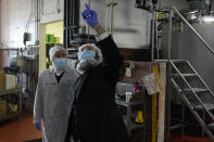 Rabbis Joseph Schwartz, left, and Mendel Einhorn confer as they supervise Hanan Products preparations for their kosher-for-passover production run, Thursday, Jan. 7, 2021, in Hicksville, N.Y. The rabbis are tasked with ensuring that the production line and foods made here meet the strict kosher requirements of Passover. (AP Photo/Seth Wenig)