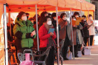 Parents pray during a special service to wish for their children's success in the college entrance exams at the Jogyesa Buddhist temple in Seoul, South Korea, Thursday, Dec. 3, 2020. Hundreds of thousands of masked students in South Korea, including dozens of confirmed COVID-19 patients, took the highly competitive university entrance exam Thursday despite a viral resurgence that forced authorities to toughen social distancing rules. (AP Photo/Ahn Young-joon)
