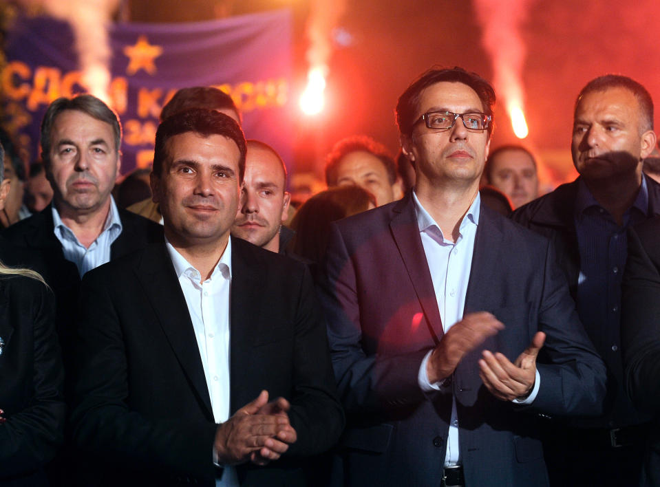 In this photo taken Tuesday, April 22, 2014, Zoran Zaev, left, the leader of the opposition social democrats (SDSM) and Stevo Pendarovski, right, a Presidential candidate supported by SDSM, applaud their supporters during a campaign rally in Macedonia's capital Skopje. Macedonia is to hold snap general elections this Sunday, as well as the second round of presidential elections. Nearly 1.8 million voters are eligible to cast their ballots at more than 3,500 polling stations, including those in diaspora. (AP Photo/Boris Grdanoski)