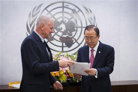 Ake Sellstrom (L), Head of the United Nations Mission to Investigate Allegations of the Use of Chemical Weapons in the Syrian Arab Republic, hands his report over to Secretary-General of the United Nations, Ban Ki-moon at the United Nations headquarters in New York December 12, 2013. REUTERS/Lucas Jackson