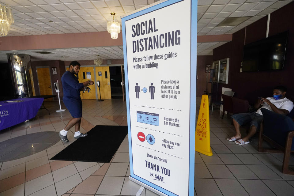 Social distancing as well as face covering is recommended at the COVID-19 vaccination site in the Rose E. McCoy Auditorium on the Jackson State University campus in Jackson, Miss., Tuesday, July 27, 2021. The Centers for Disease Control and Prevention announced Tuesday, new recommendations that vaccinated people return to wearing masks indoors in parts of the U.S. where the coronavirus is surging and also recommended indoor masks for all teachers, staff, students and visitors to schools, regardless of vaccination status. (AP Photo/Rogelio V. Solis)