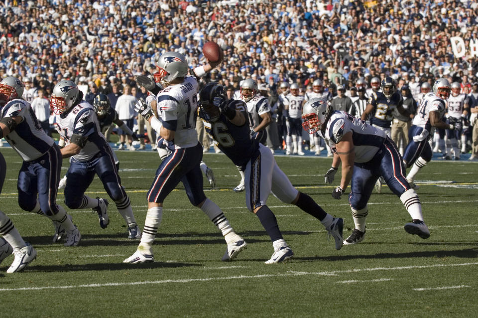 Shawne Merriman #56 on the San Diego Chargers tackles Tom Brady #12 of the New England Patriots on Jan. 14, 2007 during the AFC Playoffs in San Diego, Calif. (John Cordes for SN)