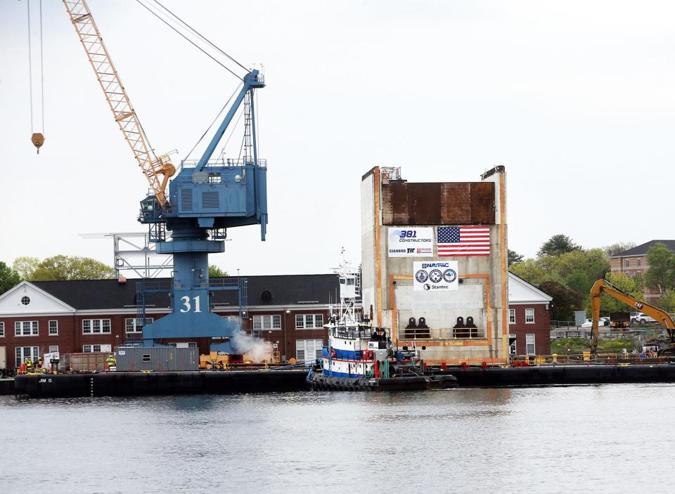The first of 27 concrete monolith structures floated down the Piscataqua River on Thursday, May 16, 2024 was delivered to the Portsmouth Naval Shipyard for the federally funded Dry Dock 1 expansion project.