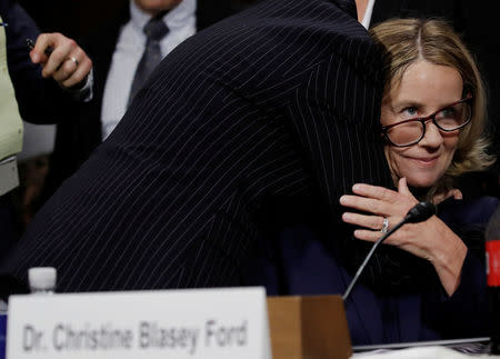 Professor Christine Blasey Ford, who has accused U.S. Supreme Court nominee Brett Kavanaugh of a sexual assault in 1982, is embraced by attorney Debra Katz at the conclusion of her testimony before a Senate Judiciary Committee confirmation hearing for Kavanaugh on Capitol Hill in Washington, U.S., September 27, 2018. REUTERS/Jim Bourg