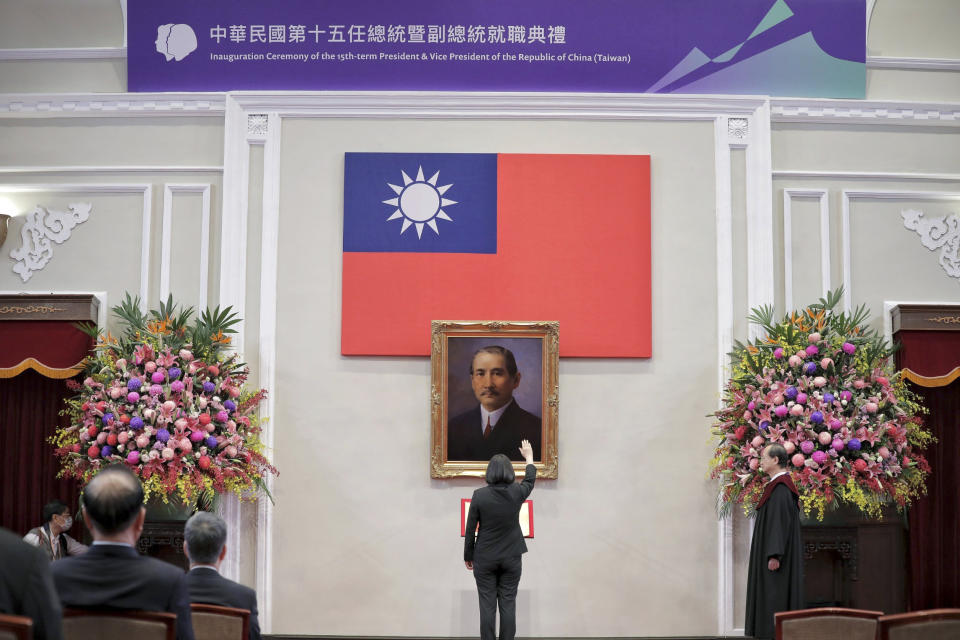 In this photo released by the Taiwan Presidential Office, Taiwanese President Tsai Ing-wen raises her hand during an inauguration ceremony before a portrait of Sun Yat-sen at the Presidential office in Taipei, Taiwan on Wednesday, May 20, 2020. Tsai was inaugurated for a second term amid increasing pressure from China on the self-governing island democracy it claims as its own territory. (Taiwan Presidential Office via AP)