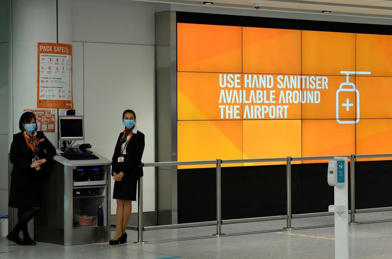 Staff are seen at an Easy Jet checking area at Gatwick Airport, in Gatwick