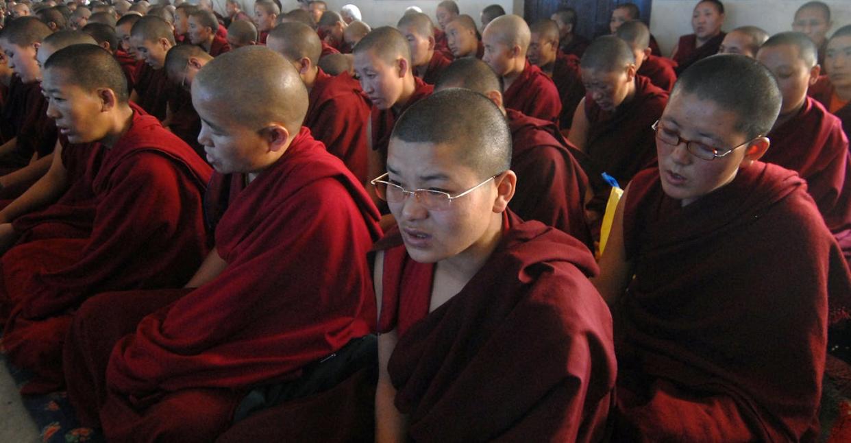 Tibetan Buddhist nuns offering prayers in Kathmandu. <a href="https://www.gettyimages.com/detail/news-photo/female-tibetan-buddhist-monks-offer-prayers-as-a-part-of-an-news-photo/1552145729?adppopup=true" rel="nofollow noopener" target="_blank" data-ylk="slk:Prakash/Mathema /AFP via Getty Images;elm:context_link;itc:0;sec:content-canvas" class="link ">Prakash/Mathema /AFP via Getty Images</a>