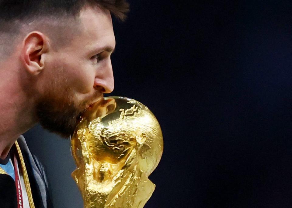 Argentina’s Lionel Messi kisses the trophy as he celebrates winning the World Cup (Reuters)