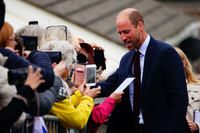 The Prince of Wales chatting to well-wishers outside a school