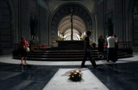 FILE PHOTO: Visitors walk past the tomb of dictator Francisco Franco at El Valle de los Caidos (The Valley of the Fallen), the giant mausoleum holding the remains of Franco, in San Lorenzo de El Escorial, outside Madrid July 12, 2011. REUTERS/Andrea Comas/File Photo