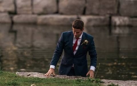 Clayton Cook waist deep in the lake after rescuing the drowning boy - Credit: Hutt Photography