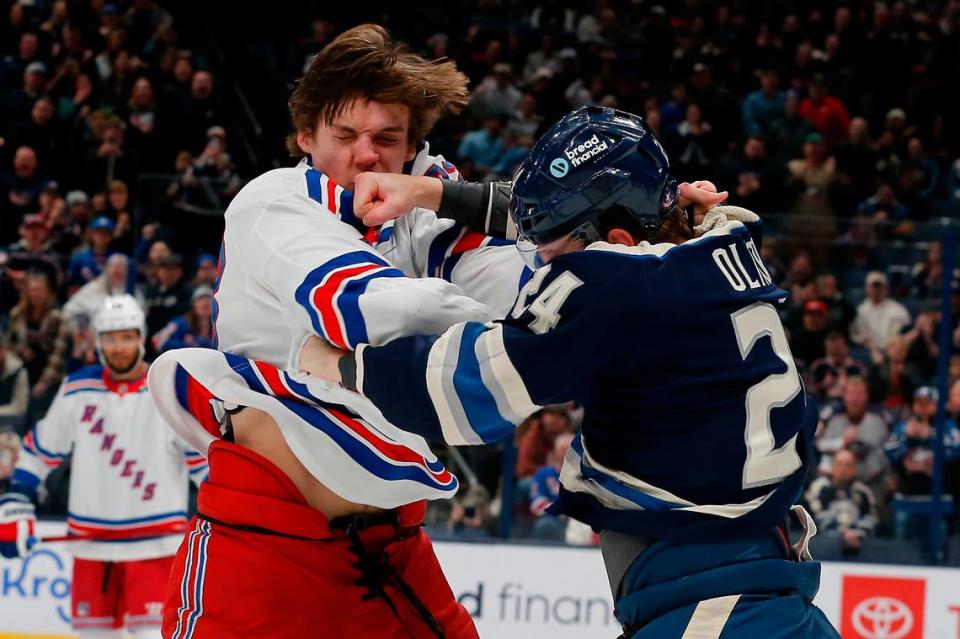 Columbus Blue Jackets right wing Mathieu Olivier (24) and New York Rangers center Matt Rempe (73) fight during the first period at Nationwide Arena.