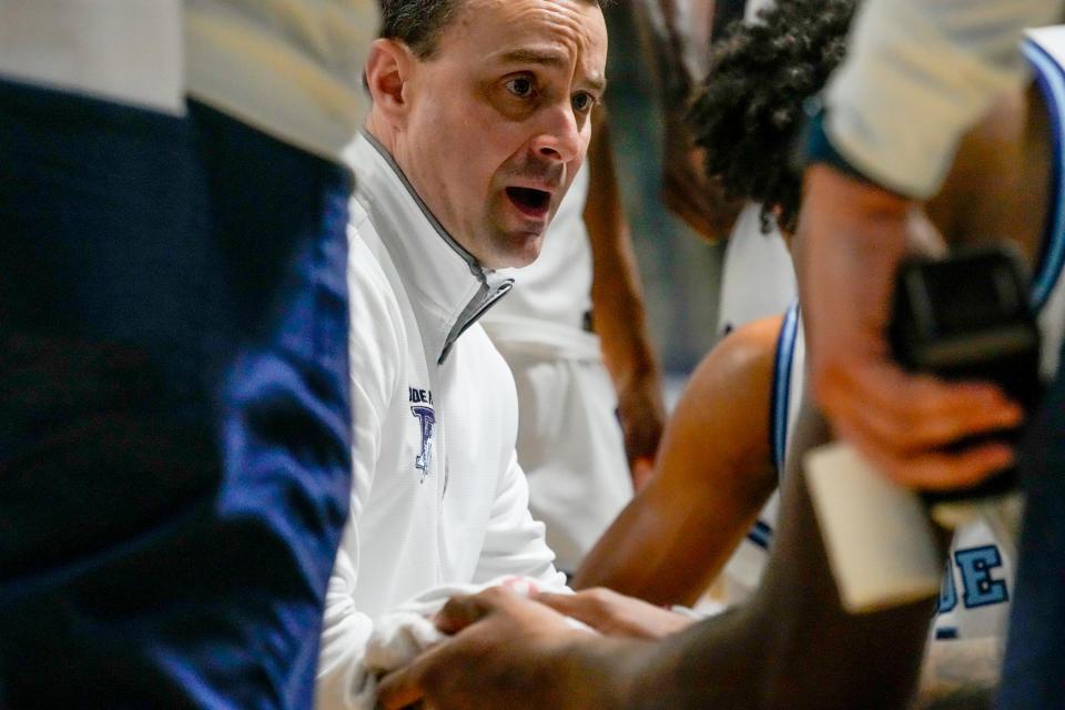 URI head men's basketball coach Archie Miller talks with his team during a timeout on Saturday.