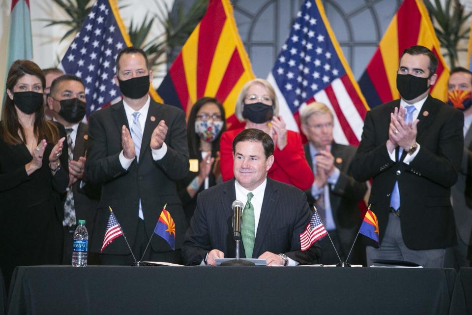 Gov. Doug Ducey speaks during the ceremonial signing of HB 2772 in the Steele Auditorium at the Heard Museum on April 15, 2021.