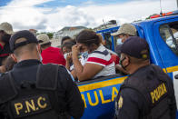 A Honduran migrant woman trying to reach the U.S. cries after she was detained in the Guatemalan department of Chiquimula, Tuesday, Jan. 19, 2021. A once large caravan of Honduran migrants that pushed its way into Guatemala last week had dissipated by Tuesday in the face of Guatemalan security forces. (AP Photo/Oliver de Ros)