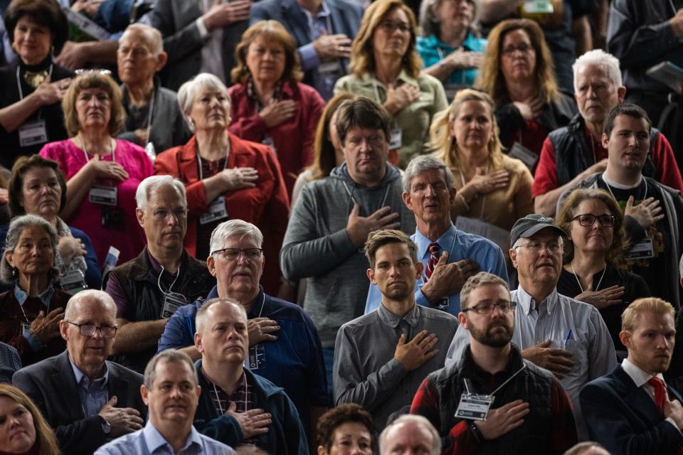 Attendees stand during the National Anthem during the Utah Republican Party Organizing Convention at Utah Valley University in Orem on April 22, 2023. | Ryan Sun, Deseret News