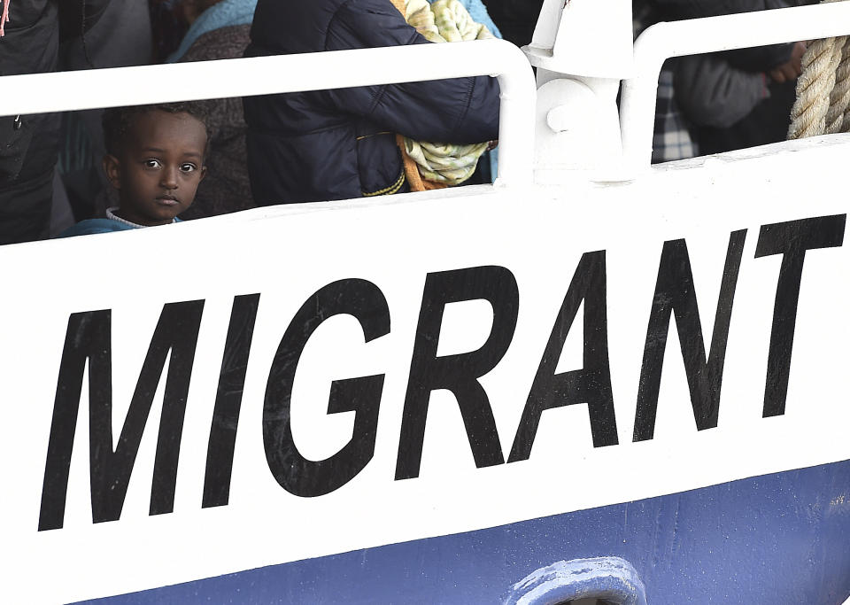 FILE - A child waits to disembark with other over 400 migrants, from the Migrant Offshore Aid Station (MOAS) vessel "Phoenix" in the harbor of Messina, Sicily, Southern Italy, May 15, 2015. Albania has agreed to host two migrant processing centers on its territory that will be run by Italy under a deal that worries human rights activists. The European Union, however, sees it as a possible future template. (AP Photo/Carmelo Imbesi, File)