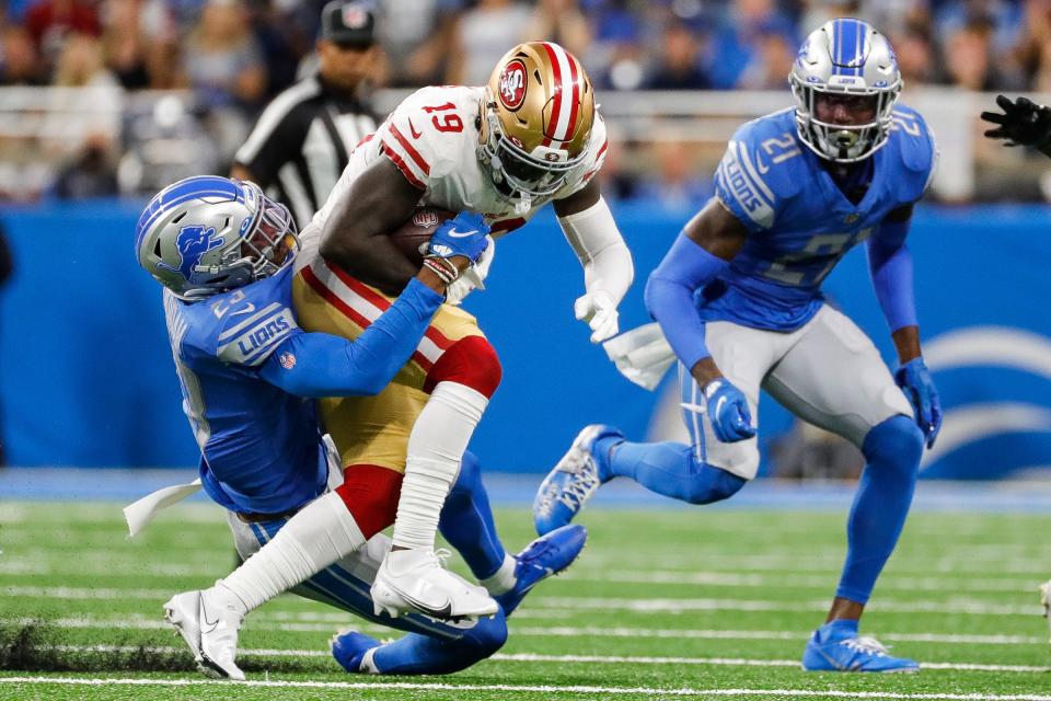 Detroit Lions cornerback Jeff Okudah (23) tackles San Francisco 49ers wide receiver Deebo Samuel (19) during the first half at Ford Field in Detroit on Sunday, Sept. 12, 2021.