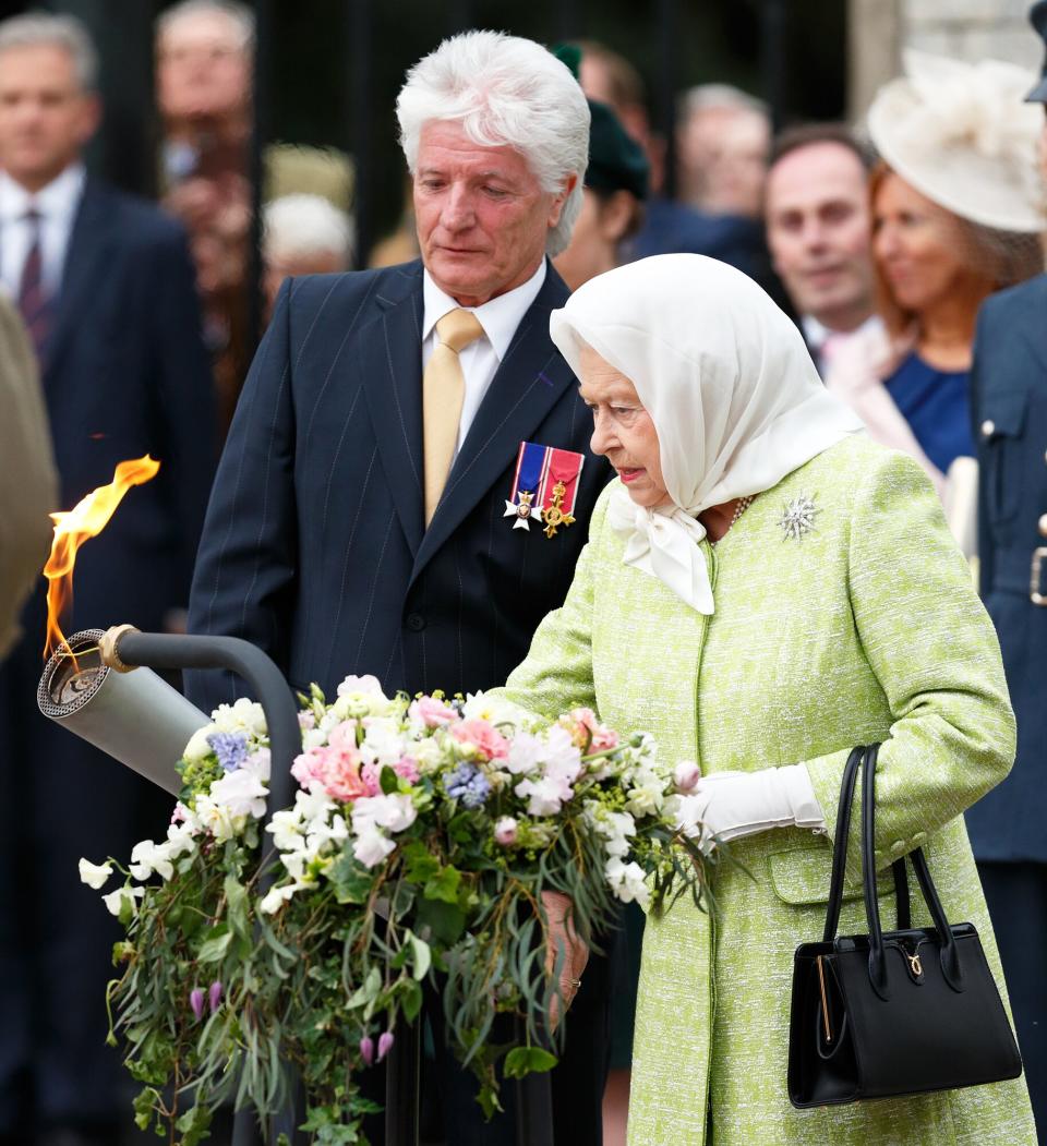 Bruno Peek looks on as Queen Elizabeth II