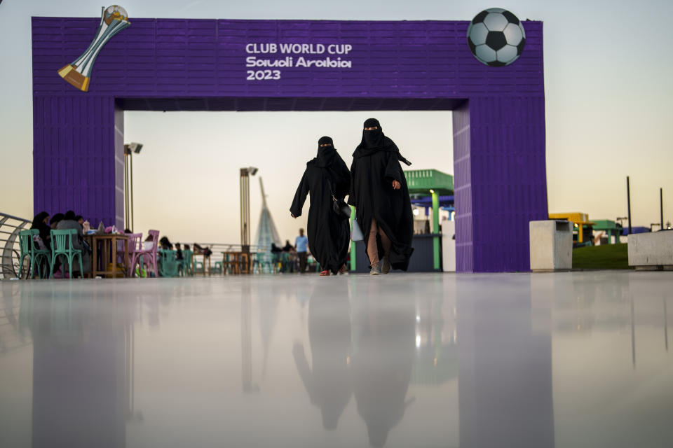 Women walk in front of a fan zone during the Soccer Club World Cup at the Jeddah Corniche in Jeddah, Saudi Arabia, Wednesday, Dec 13, 2023. (AP Photo/Manu Fernandez)