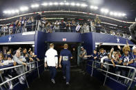 Dallas Cowboys head coach Jason Garrett, center, walks off the field past fans after their NFL football game against the Buffalo Bills in Arlington, Texas, Thursday, Nov. 28, 2019. (AP Photo/Ron Jenkins)