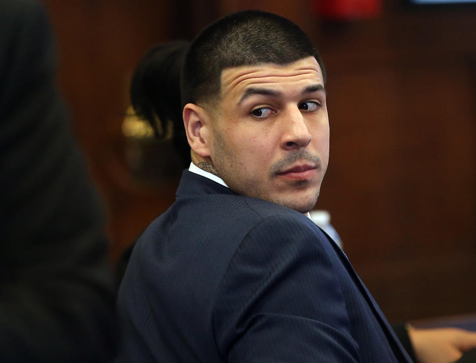 Aaron Hernandez looks back from the defense table at his double murder trial