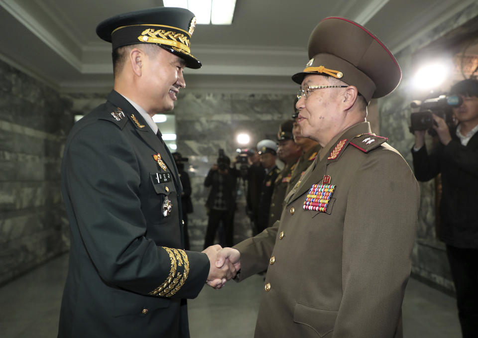 South Korean Maj. Gen. Kim Do-gyun, left, shakes hands with his North Korean counterpart Lt. Gen. An Ik San upon his arrival at the border village of Panmunjom, North Korea, Friday, Oct. 26, 2018. North and South Korea are holding military talks on their border to discuss implementing a broad-reaching military agreement last month to reduce tensions. (Korea Pool/Yonhap via AP)