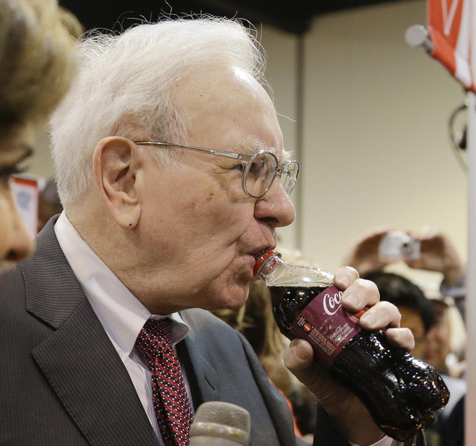 Berkshire Hathaway Chairman and CEO Warren Buffett drinks from a bottle of Cherry Coke prior to the annual shareholders meeting on Saturday, May 3, 2014, in Omaha, Neb. During the meeting Buffett told shareholders he had abstained from voting Berkshire's 400 million shares against Coca Cola's compensation plan even though he had long advocated against exorbitant executive pay. (AP Photo/Nati Harnik)