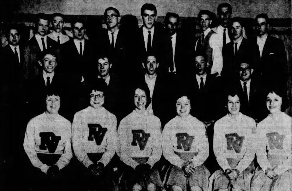 The 1962-63 boys basketball team and cheerleaders pose for photos during a reception at the high school following their Elite Eight appearance in Troy following a 39-36 loss to Jackson Center.