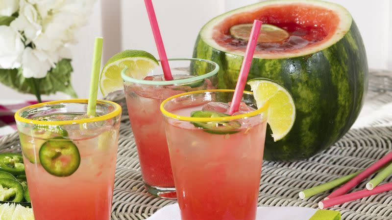 three spicy watermelon cocktails arranged on a wicker tray