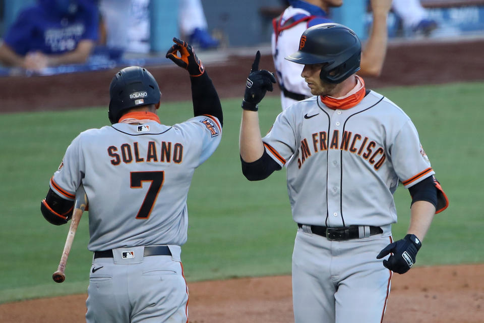 LOS ANGELES, CALIFORNIA - AUGUST 08: Austin Slater #13 of the San Francisco Giants celebrates his home run against the Los Angeles Dodgers with Donovan Solano #7 during the third inning at Dodger Stadium on August 08, 2020 in Los Angeles, California. (Photo by Katelyn Mulcahy/Getty Images)