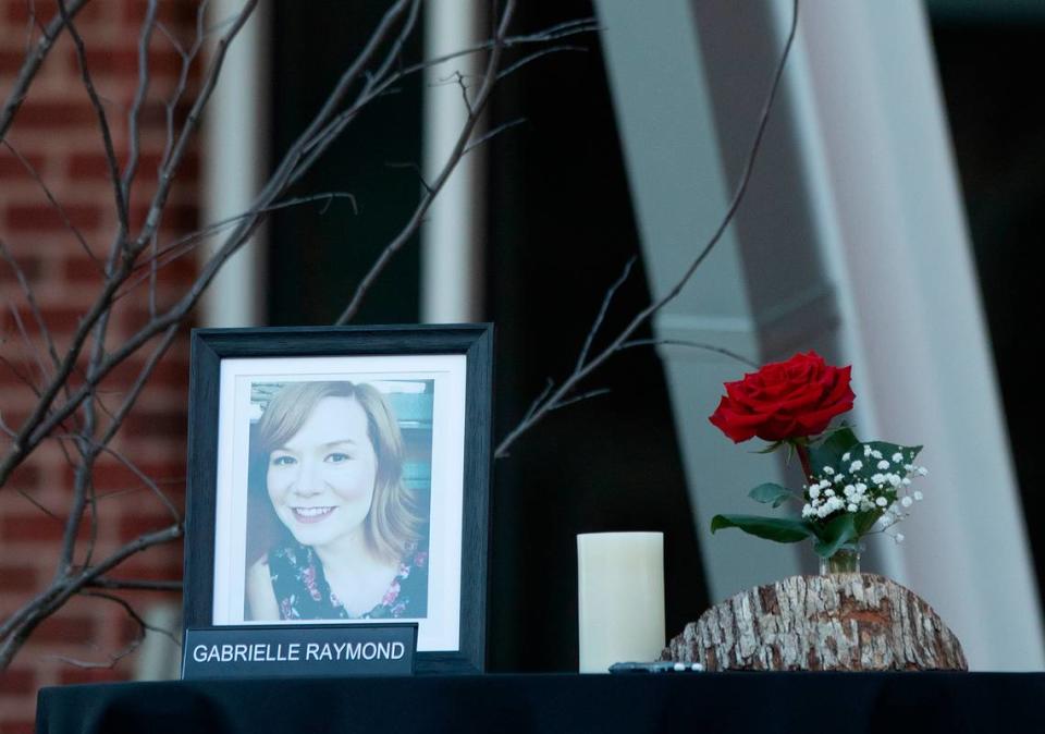 A photograph of Gabrielle Raymond sits on a table prior to a vigil held outside the Apex Town Hall on Monday, Jan. 29, 2024, to honor Raymond and Nancy Taylor, who were shot and killed in an Apex neighborhood on Jan. 15.