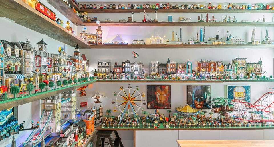 The Lego collection is stored on shelves reaching as high as the top of the wall.